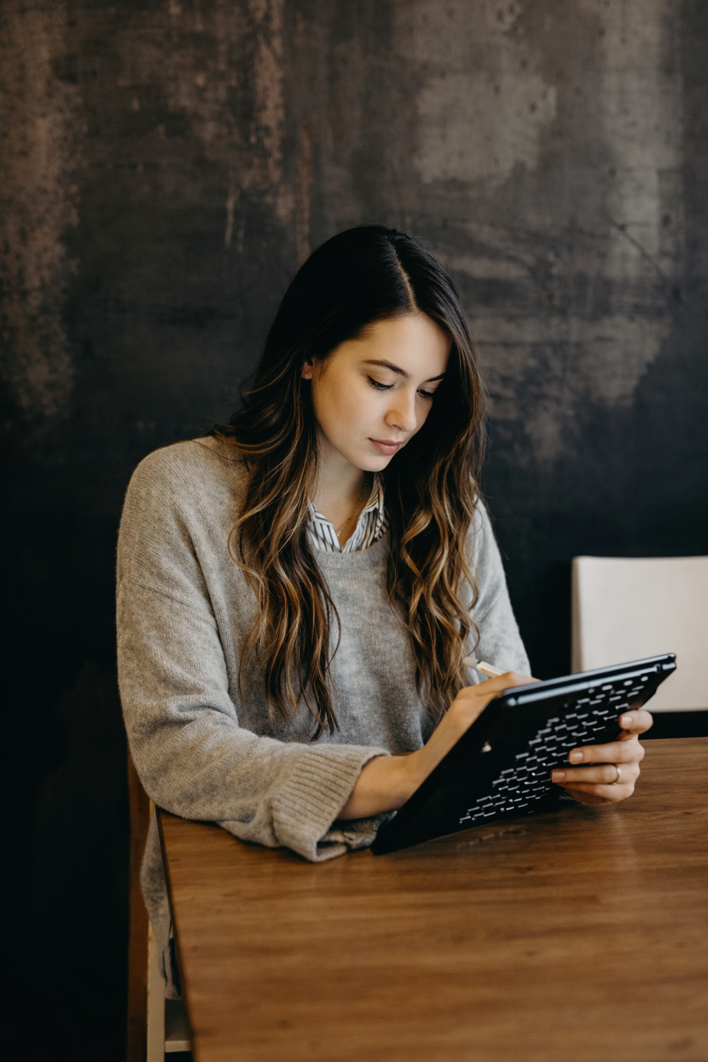 A woman reviewing legal documents on a tablet